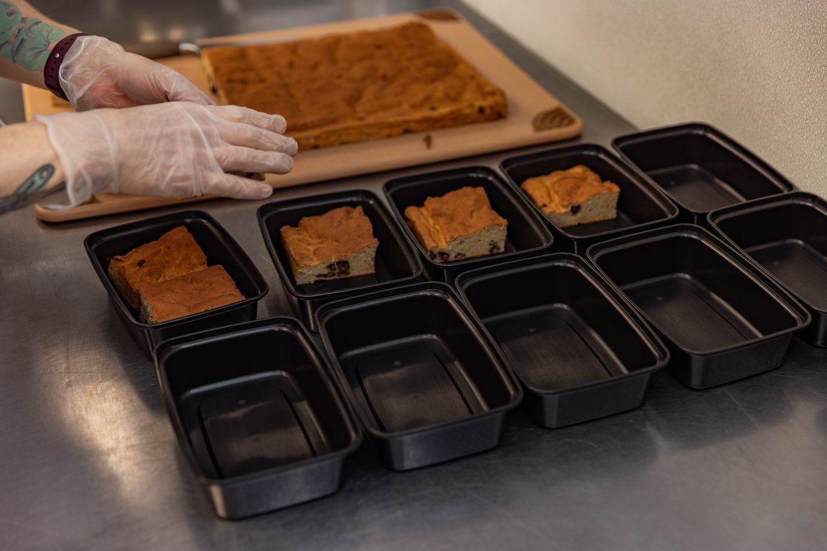 Meals being portioned into containers in the Strong Kitchen