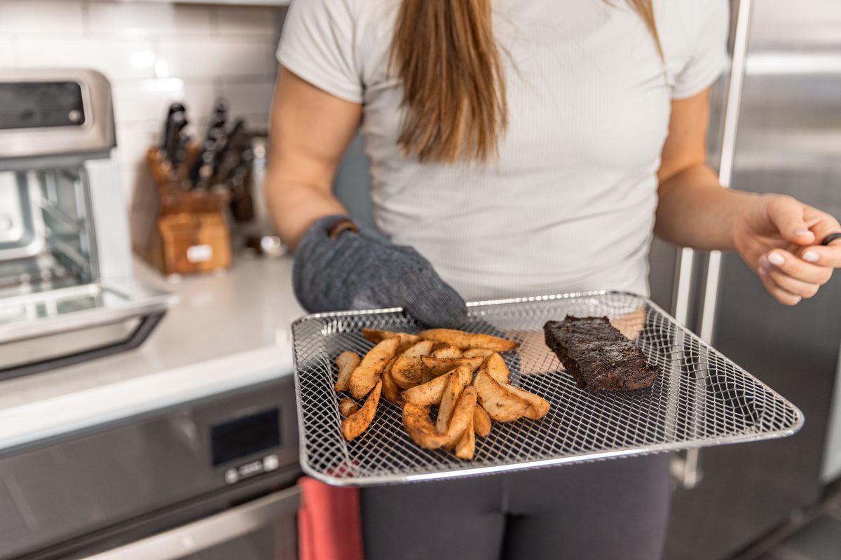 Steak and roasted potatoes coming out of the oven on a tray